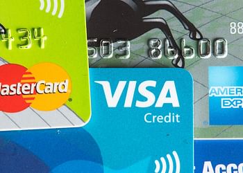 How do credit card companies make money from credit cards that offer cashback?